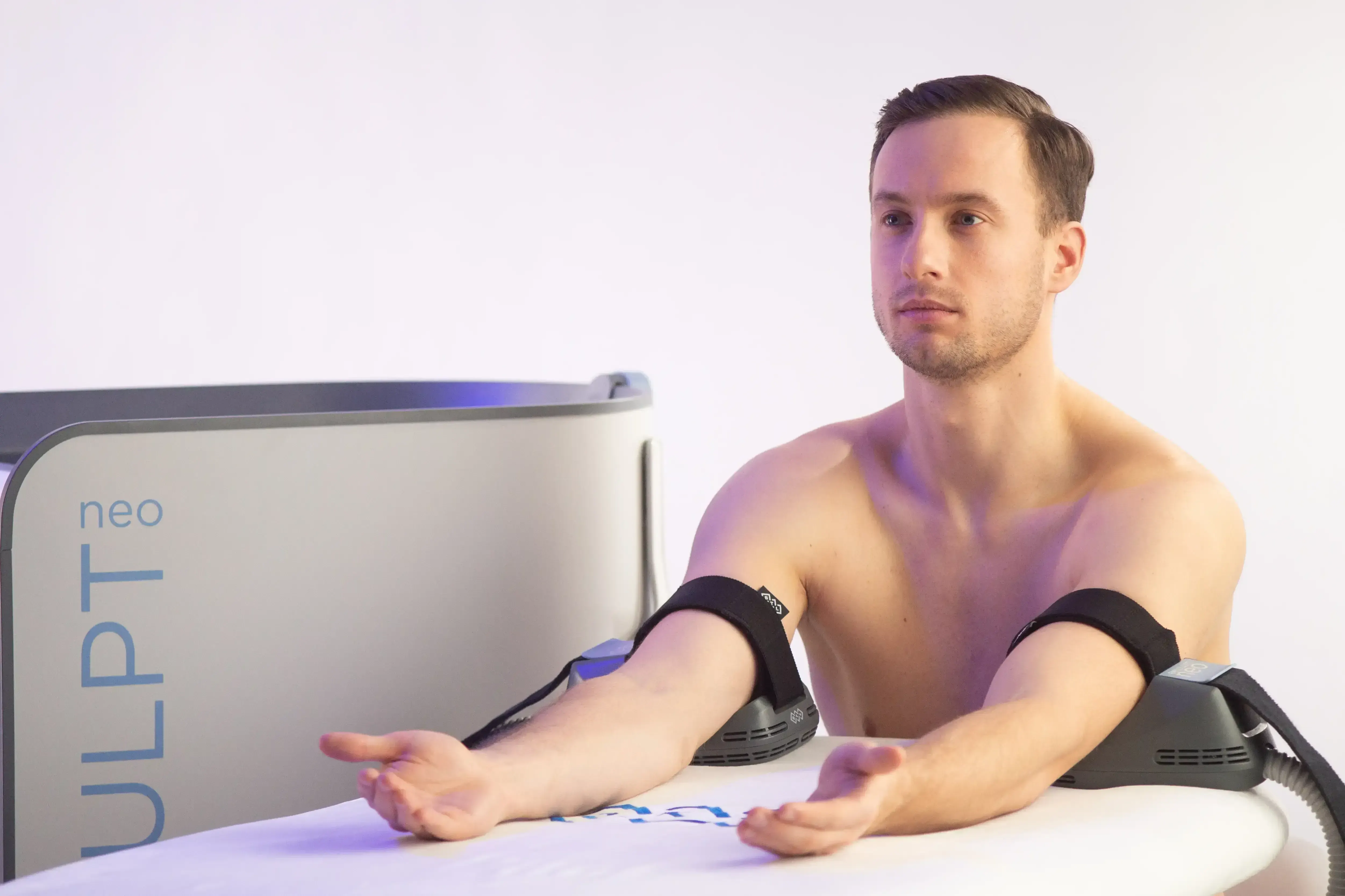 Male patient receiving EMSCULPT NEO body sculpting at Chandra Wellness Center in Ocala, FL